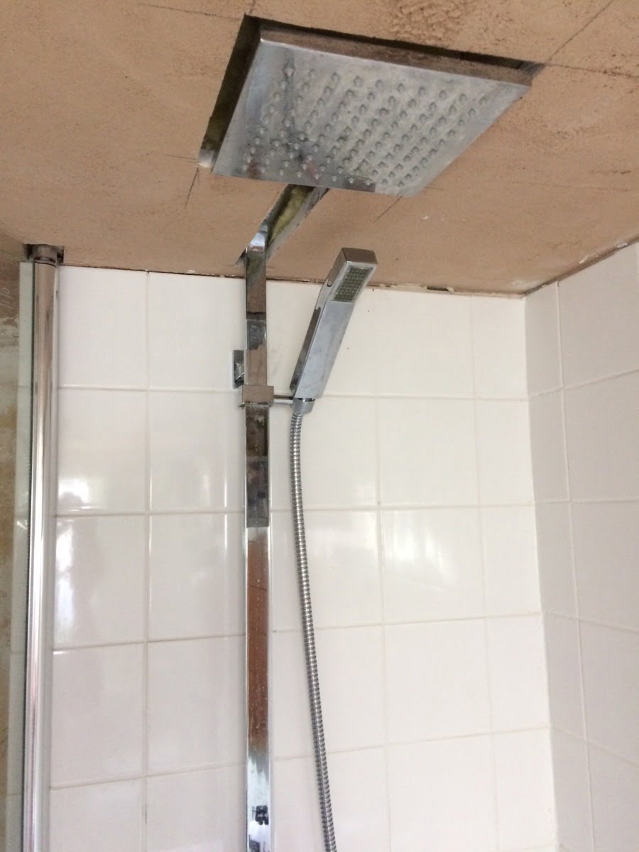 Is this my toughest makeover yet? My beautiful best friend, Nicola, has been living with this bathroom for SIX years. Yep, you read that right - six years with half-tiled walls, no flooring, a faulty bath and wonky shower head. Look at the dangling spotlights - ekk! I adore my best friend, and I wanted this hardworking mum-of-two to have the beautiful bathroom she deserves. Saying all that this bathroom makeover has to be one of my biggest challenges yet. I've donned my styling gloves, and set to work giving her the best bathroom makeover in possible the smallest-space-ever with the very generous help of Bathroom Takeaway and Tons of Tiles. Let me walk you through the planning stages and my ideas for the space. maxine brady welovehomeblog A before shot of the shower head