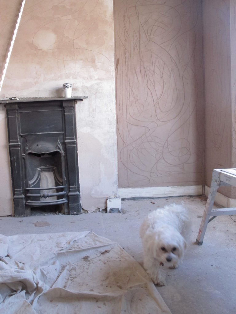Guide to how to DIY your walls to get a distressed look by hacking off the plaster and treating it. It's cheap to do, looks brilliant and creates a real statement look in a home by interior stylist Maxine Brady.