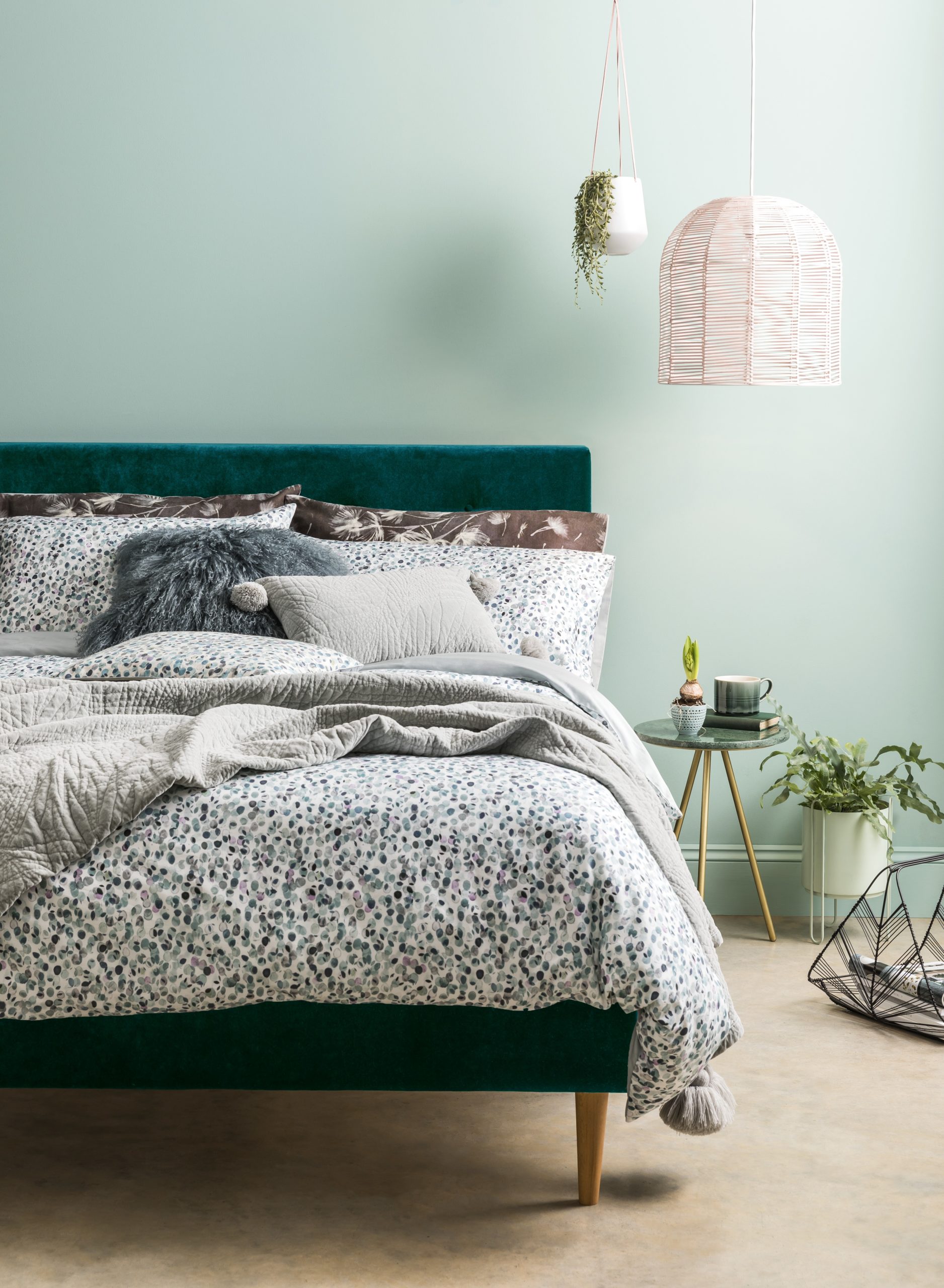 green bedroom with woolen throw and statement lighting and velvet bed Tips and tricks for styling your home with intention so that you can create a space you'll love by interior stylist Maxine Brady from we love home blog