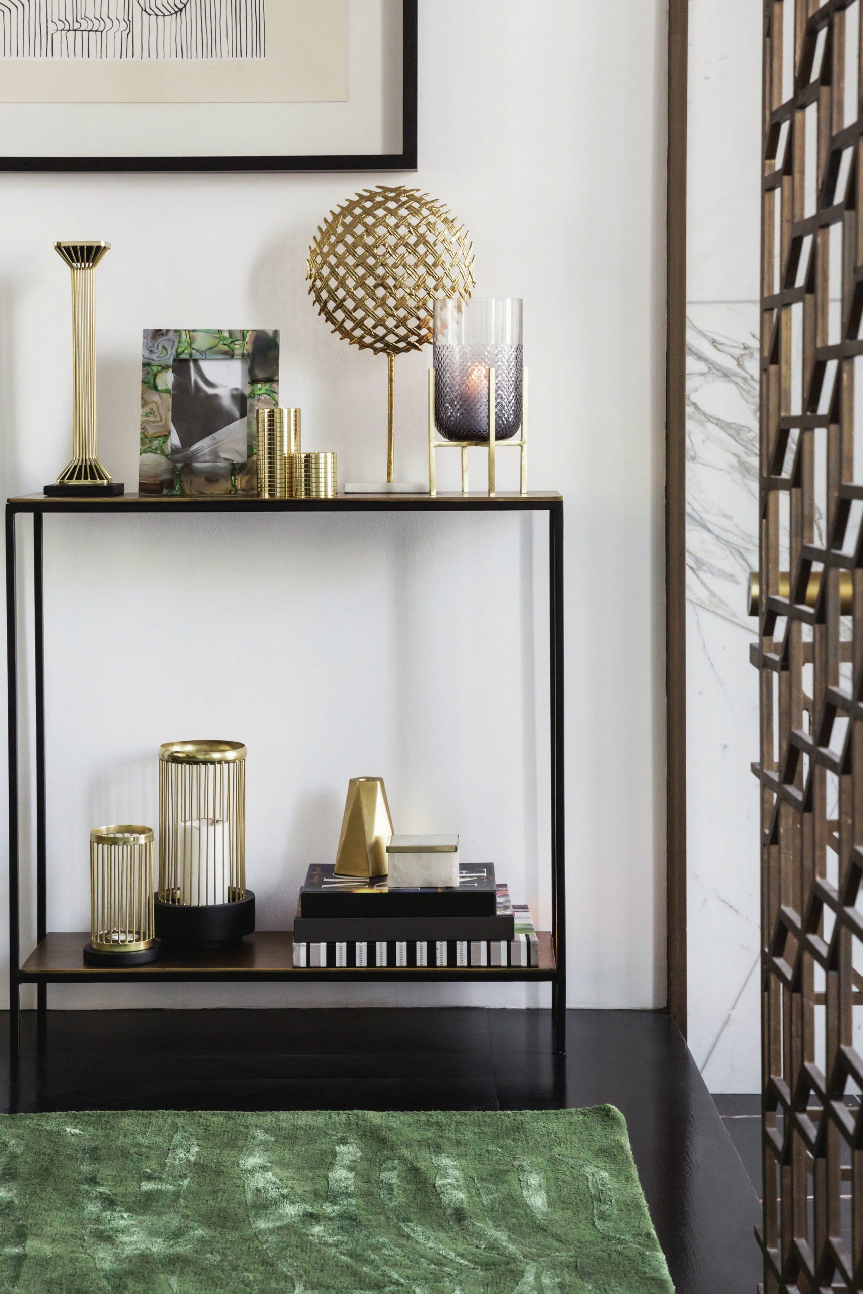 small shelving unit with gold accessories and candles